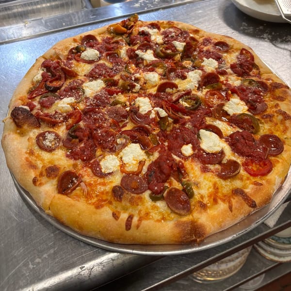 A Bar Jawn pizza with pepperoni, jalapeños, ricotta cheese, and red sauce on a metal tray.